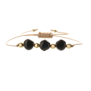 Detail of adjustable woven cord bracelet with irregular black stones and gold beads