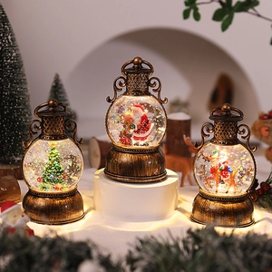 Close-up of vintage bronze Christmas lanterns with Santa Claus and sparkling snow effect