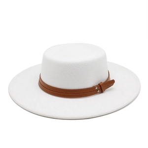Detail of white wool boater hat featuring a brown leather strap and silver metal buckle