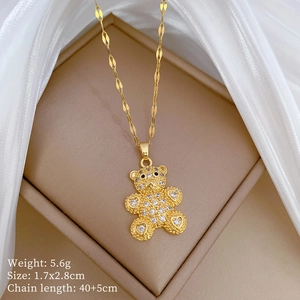Macro detail of a gold-plated teddy bear pendant with micro-inlaid zircon on a box