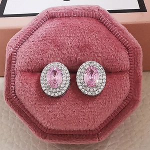 Detailed view of pink zircon stud earrings in an octagonal velvet jewelry gift box