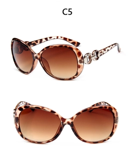 Detail of leopard print large frame sunglasses with silver metal chain link temples