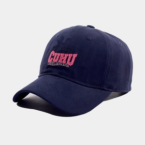 Detail shot of the pink 3D embroidered CUHU logo on a dark blue cotton twill baseball cap