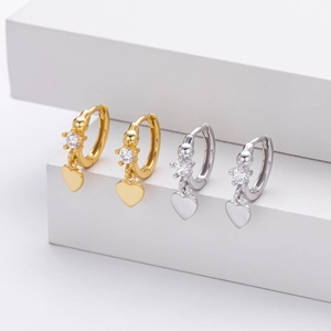 Close-up of S925 silver heart hoop earrings with cubic zirconia on white steps