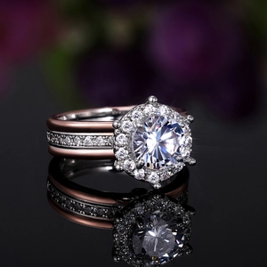 Macro shot of two-tone halo engagement ring with stacked bands and round-cut diamond