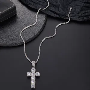 Macro shot of silver cross pendant with micro-paved zircons and twist chain