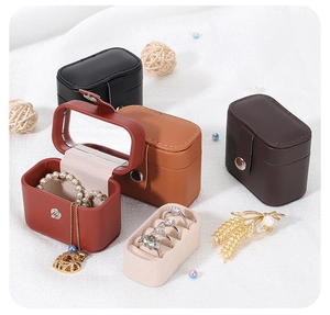 Macro detail of portable mini leather jewelry boxes in red, brown, and black finishes