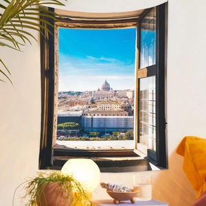 Cozy room interior featuring a decorative wall tapestry with a scenic Rome city view