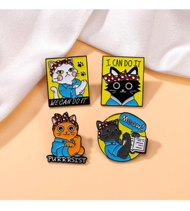 Detailed view of four cartoon cat enamel pins with motivational Rosie the Riveter themes