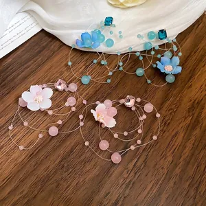 Exquisite handmade floral tassel earrings with blue and pink fabric petals and crystals