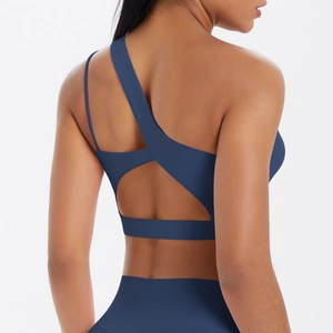 Detail of navy yoga sports bra featuring asymmetric strap and triangular back cutout