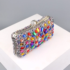Detail of colorful gemstone sunburst pattern on silver rhinestone evening clutch bag