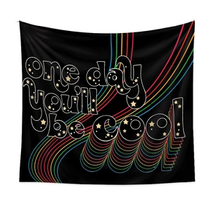 Detail of bohemian black wall tapestry with retro rainbow stripes and starry lettering