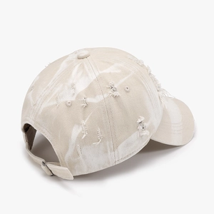 Distressed beige tie-dye baseball cap with ripped details and adjustable back strap