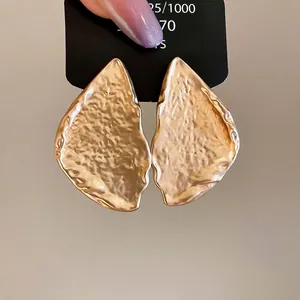 Minimalist thick triangular metal earrings with vintage hammered texture in matte gold