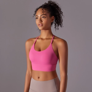 Close-up of bright pink yoga bra with cross straps and high-elastic nylon fabric