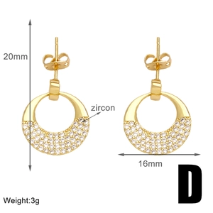 Detail view of gold C-shaped earrings with white zircon accents and size dimensions