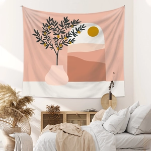 Minimalist bohemian tapestry with olive branch and sun design hanging in a cozy bedroom