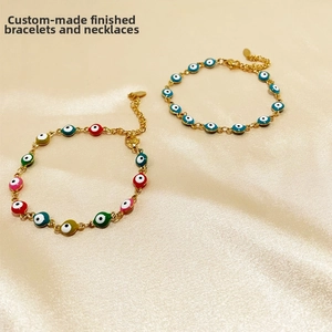 Close-up of colorful Turkish Evil Eye beads on golden stainless steel link chains