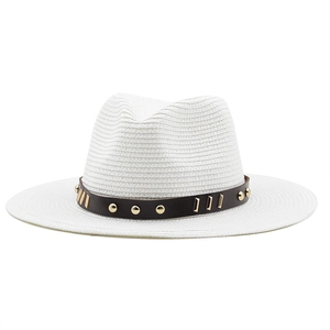 Detail of white woven straw fedora with brown leather band and gold metal studs