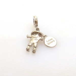 Macro detail of silver scarecrow charm with Love guard engraved tag and crystal joints