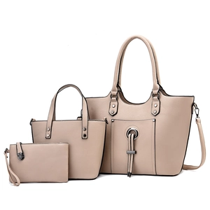 Three-piece beige PU leather handbag set including large tote, handbag, and clutch pouch