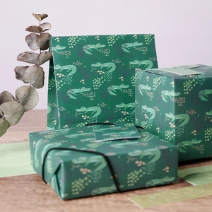 Jungle themed gift packaging set with green crocodile pattern paper boxes and a gift bag