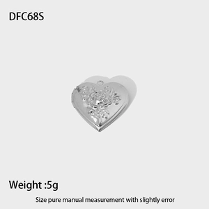 Detail showing high-polished silver heart locket with intricate rose relief engraving