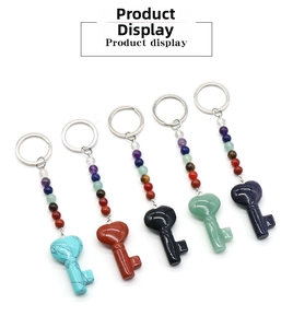 Macro detail of five heart-shaped gemstone key pendants with colorful chakra beads