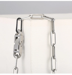 Close-up of minimalist silver rectangular link chain with industrial geometric clasp