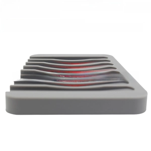 Detailed view of grey silicone soap holder featuring a curved non-slip drainage frame