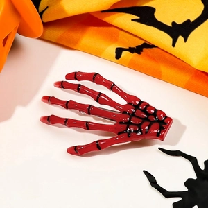 Close-up of red skeleton hand hair clip with black joints for Halloween hair styling