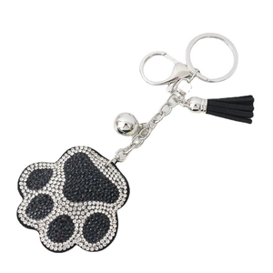 Fashion bear paw rhinestone keychain with black tassel and silver bell on white background