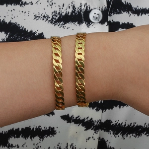 Close-up of double layer gold plated curb chain bracelet worn on a zebra print sleeve