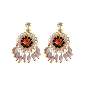 Ethnic style flower stud earrings with purple beads and rhinestones on white background