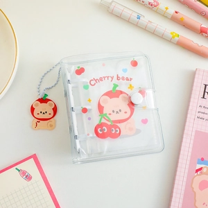 Detail of transparent PVC 3-hole mini binder featuring cartoon bear and matching keychain