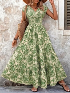 Detail view of V-neckline and smocked waist on vintage green bohemian maxi dress