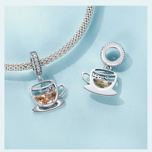 Macro shot of 925 silver coffee cup charm with brown gemstone and white zircon detail