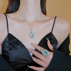 Detailed view of the luxury blue teardrop gemstone necklace and matching ring set