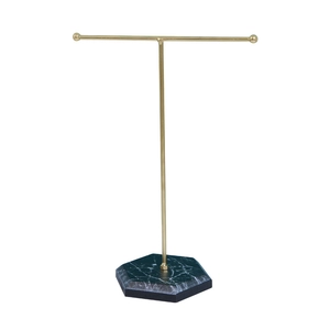 Minimalist T-bar jewelry stand with gold metal arm and green marble hexagonal base