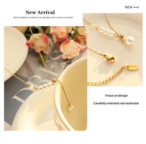 Close-up of golden pearl necklace with K18 engraved tag and elegant lobster clasp detail