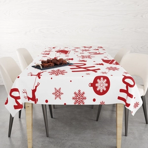 Detailed view of red Christmas reindeer and snowflake patterns on a white tablecloth