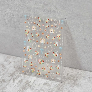 Detail of ultra-thin nail art stickers featuring pink peaches, white rabbits, and bows