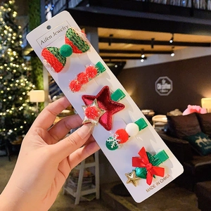 Detailed set of five Christmas hair clips with festive bow, star, and snowflake motifs