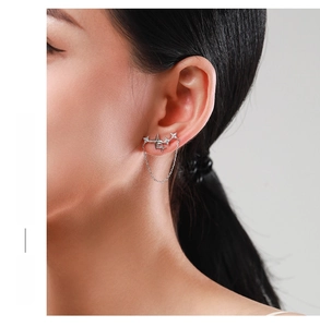Close-up of S925 sterling silver four-pointed star stud earrings with delicate chain