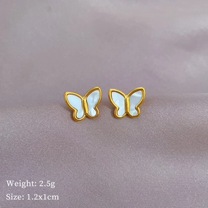 Minimalist titanium steel butterfly studs with white shell inlay on purple silk fabric