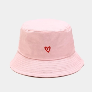 Close-up of red heart embroidery on a pink cotton bucket hat with parallel stitching