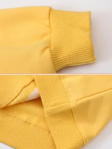 Yellow long sleeve pullover for girls with ribbed cuffs and hem detail on white background