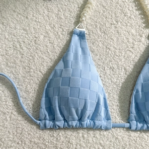 Detail view of light blue checkered bikini top with elegant faux pearl beaded straps