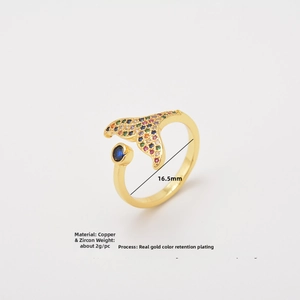 Macro shot of colorful zircon-studded copper fish tail ring with blue gemstone